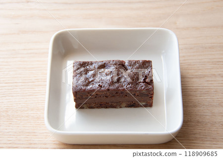 Chocolate brownie on a white plate Chocolate brownie on a white plate 118909685