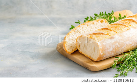 Freshly baked bread loaf with herbs on wooden board 118910618