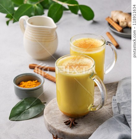 Turmeric golden milk latte with spices and honey. Detox, immunity boosting, anti-inflammatory drink Turmeric golden milk latte with spices and honey. Detox, immunity boosting, anti-inflammatory drink 118911634