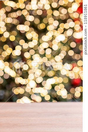 Wooden empty tabletop in front of a Christmas tree with red decorations and lights in blurred. Wooden empty tabletop in front of a Christmas tree with red decorations and lights in blurred. 118911861
