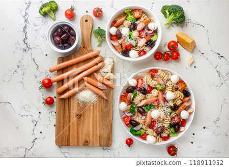 Colorful pasta salad with fresh vegetables and sausages Colorful pasta salad with fresh vegetables and sausages 118911952