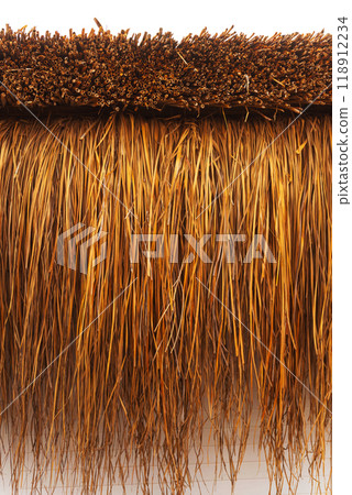 Straw on the roof of dried reeds. The texture of dry grass on a white background Straw on the roof of dried reeds. The texture of dry grass on a white background 118912234