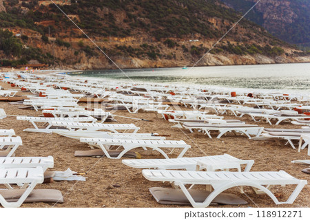 Empty beautiful beach with white sun loungers  118912271