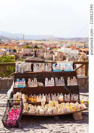 Elegant candles on a table, with a vibrant city backdrop 118912340