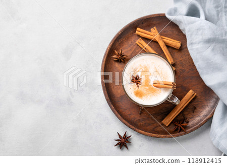 Traditional Indian masala chai latte in a glass cup. Hot drink with milk, spices and herbs  118912415