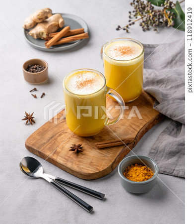 Turmeric golden milk latte with spices and honey. Detox, immunity boosting, anti-inflammatory Turmeric golden milk latte with spices and honey. Detox, immunity boosting, anti-inflammatory 118912419