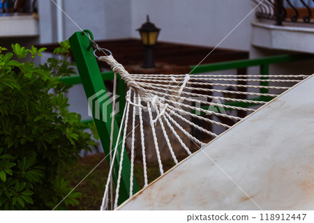 The base of a hammock tied to a pole in the garden The base of a hammock tied to a pole in the garden 118912447
