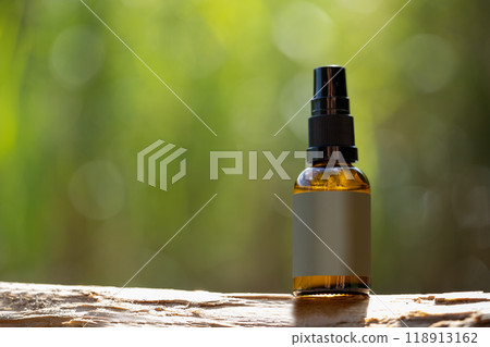 Amber Glass Spray Bottle on Wooden Surface Amber Glass Spray Bottle on Wooden Surface 118913162