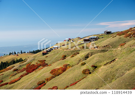 Beautiful autumn mountain landscape with colorful trees and old houses. 118914439