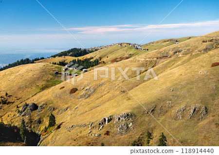 Beautiful autumn mountain landscape with colorful trees and old houses.  118914440