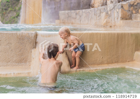 Toddler and teenage boys bathing in the hot springs of Grutas Tolantongo, Mexico. Family adventure, relaxation, and natural wellness concept 118914719