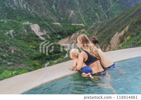 Mother with her toddler and teenage sons bathing in the hot springs of Grutas Tolantongo, Mexico. Family adventure, relaxation, and natural wellness concept 118914861