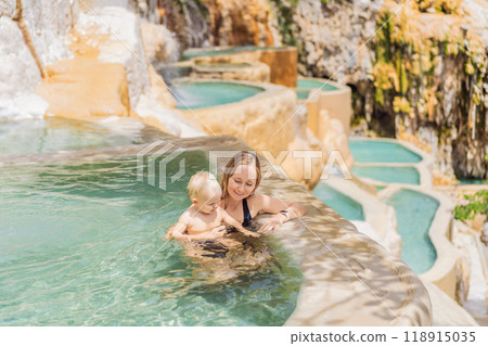 Mother with her toddler son bathing in the hot springs of Grutas Tolantongo, Mexico. Family adventure, relaxation, and natural wellness concept Mother with her toddler son bathing in the hot springs of Grutas Tolantongo, Mexico. Family adventure, relaxation, and natural wellness concept 118915035