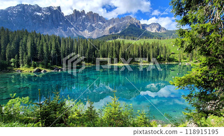 Italy Idyllic nature scenery- trasparent mountain lake Carezza surrounded by Dolomites rocks- one of the most beautiful lakes of Alps. South Tyrol region. Italy Idyllic nature scenery- trasparent mountain lake Carezza surrounded by Dolomites rocks- one of the most beautiful lakes of Alps. South Tyrol region. 118915195