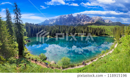 Italy Idyllic nature scenery- trasparent mountain lake Carezza surrounded by Dolomites rocks- one of the most beautiful lakes of Alps. South Tyrol region. Italy Idyllic nature scenery- trasparent mountain lake Carezza surrounded by Dolomites rocks- one of the most beautiful lakes of Alps. South Tyrol region. 118915196