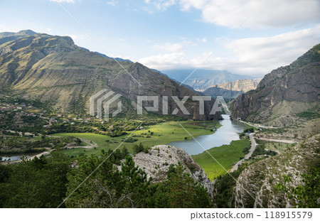 Beautiful landscape with mountains, valley and a river on a sunny summer day with clouds. Dagestan Beautiful landscape with mountains, valley and a river on a sunny summer day with clouds. Dagestan 118915579