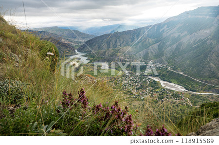 Beautiful landscape with mountains, valley and a river on a sunny summer day with clouds. Dagestan Beautiful landscape with mountains, valley and a river on a sunny summer day with clouds. Dagestan 118915589