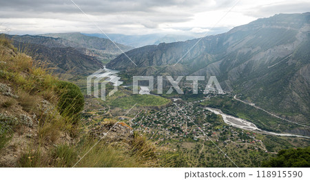 Beautiful landscape with mountains, valley and a river on a sunny summer day with clouds. Dagestan Beautiful landscape with mountains, valley and a river on a sunny summer day with clouds. Dagestan 118915590