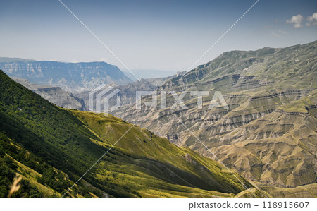 Beautiful panoramic view of the mountains with forests on a sunny summer day. 118915607