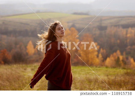girl enjoying warm autumn in the park, hello autumn, autumn mood girl enjoying warm autumn in the park, hello autumn, autumn mood 118915738