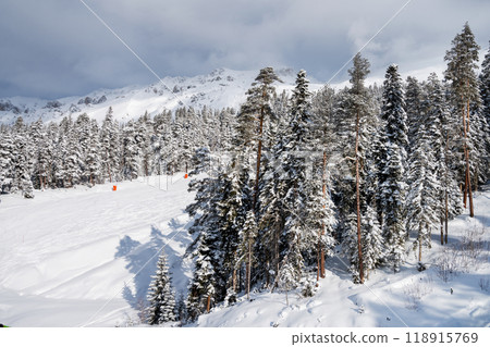 Beautiful landscape of the Arkhyz ski resort with mountains, snow and forest on a sunny winter day. Beautiful landscape of the Arkhyz ski resort with mountains, snow and forest on a sunny winter day. 118915769