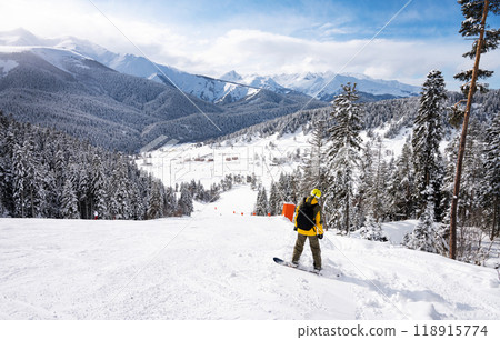 Beautiful landscape of the Arkhyz ski resort with mountains, snow, forest and man snowboarder Beautiful landscape of the Arkhyz ski resort with mountains, snow, forest and man snowboarder 118915774