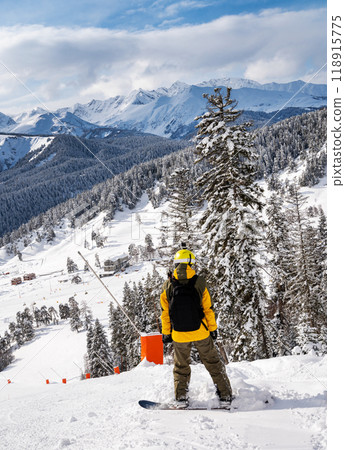 Beautiful landscape of the Arkhyz ski resort with mountains, snow, forest and man snowboarder  118915775