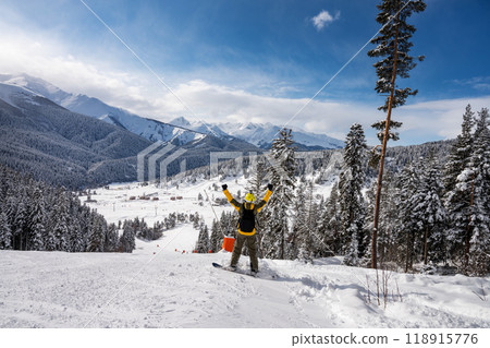Beautiful landscape of the Arkhyz ski resort with mountains, snow, forest and man snowboarder Beautiful landscape of the Arkhyz ski resort with mountains, snow, forest and man snowboarder 118915776
