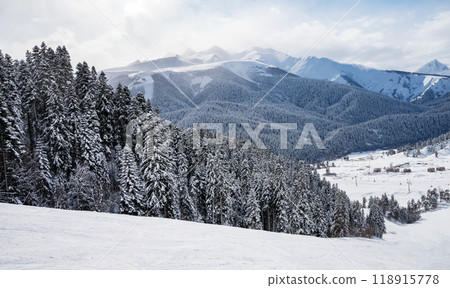 Beautiful landscape of the Arkhyz ski resort with mountains, snow, forest and track  118915778