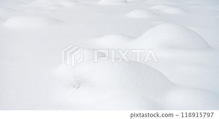 Snowy landscape with rounded hills, smooth texture and untouched snow. Concept for design Snowy landscape with rounded hills, smooth texture and untouched snow. Concept for design 118915797