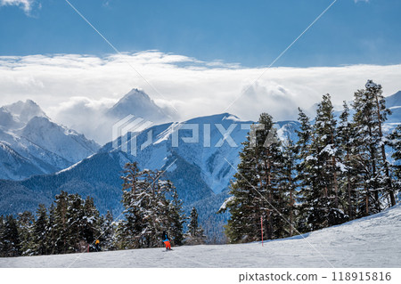 Beautiful landscape of the Arkhyz ski resort with mountains, snow, forest, skiers and snowboarders  118915816