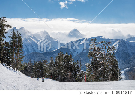 Beautiful landscape of the Arkhyz ski resort with mountains, snow, forest, skiers and snowboarders Beautiful landscape of the Arkhyz ski resort with mountains, snow, forest, skiers and snowboarders 118915817