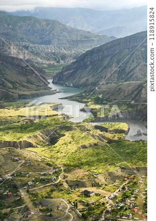 Beautiful landscape with mountains, valley and a river on a sunny summer day with clouds. Dagestan Beautiful landscape with mountains, valley and a river on a sunny summer day with clouds. Dagestan 118915824