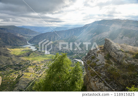 Beautiful landscape with mountains, valley and a river on a sunny summer day with clouds. Dagestan Beautiful landscape with mountains, valley and a river on a sunny summer day with clouds. Dagestan 118915825