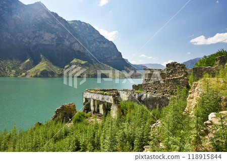 Beautiful landscape with mountains, river and old ancient fortress on a sunny summer day with clouds 118915844