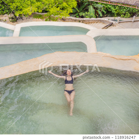 Female tourist at the hot springs of Grutas Tolantongo, Mexico. Adventure, relaxation, and natural wellness concept Female tourist at the hot springs of Grutas Tolantongo, Mexico. Adventure, relaxation, and natural wellness concept 118916247