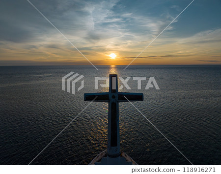 A large cross in the sea with sunset background. Sunken Cemetery in Camiguin Island. Philippines. 118916271