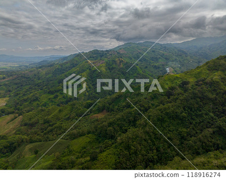 Tropical mountain slopes and hills with lush foliage in the Philippines. Blue sky and clouds. Mindanao. 118916274