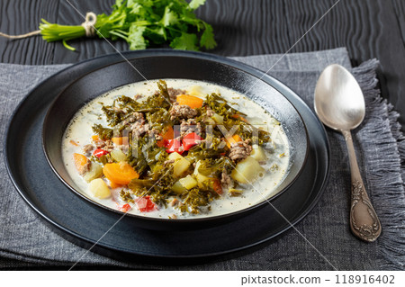 ground beef veggies kale soup in black bowl 118916402