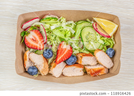 Fresh salad with chicken fillet and berries in a paper disposable plate, balanced nutrition, healthy snack. top view Fresh salad with chicken fillet and berries in a paper disposable plate, balanced nutrition, healthy snack. top view 118916426