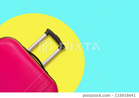 Pink suitcase on a yellow and blue background. Travel concept. Pink suitcase on a yellow and blue background. Travel concept. 118916641