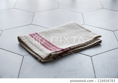 Empty kitchen napkin on gray ceramic tile in hexagon shape. Empty kitchen napkin on gray ceramic tile in hexagon shape. 118916783