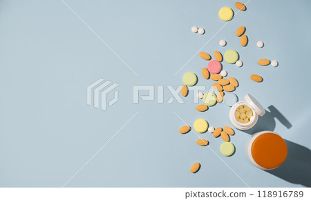 Assorted pills and nutritional supplements in different colors with white bottles Assorted pills and nutritional supplements in different colors with white bottles 118916789