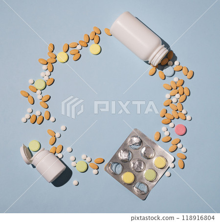Flat lay of a variety of pills, vitamins and nutritional supplements of different colors and shapes  118916804