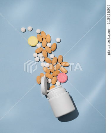 A variety of tablets and nutritional supplements of different colors are dynamically poured out A variety of tablets and nutritional supplements of different colors are dynamically poured out 118916805