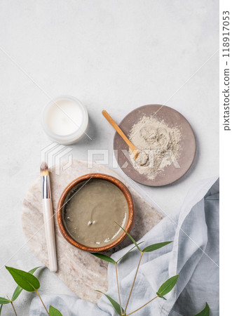 Organic cosmetic with blue clay on a marble board with brush, candle and eucalyptus branch Organic cosmetic with blue clay on a marble board with brush, candle and eucalyptus branch 118917053