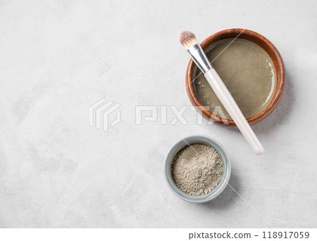 Blue clay with brush on a light background. Concept for preparing homemade skincare cosmetics. 118917059