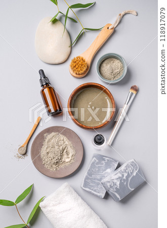 Organic cosmetic with blue clay, serum, soap, brush and towel on a light background with shadow. 118917079