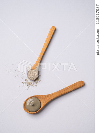 Blue clay in a spoon on a light background. Concept for preparing homemade skincare cosmetics Blue clay in a spoon on a light background. Concept for preparing homemade skincare cosmetics 118917087
