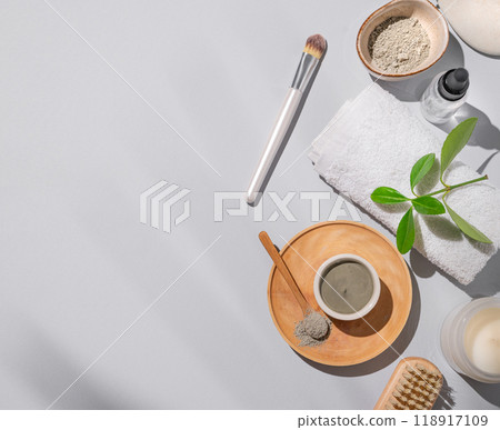 Spa trearment. flat lay of blue clay in a bowl and spoon on a wooden plate on a light background Spa trearment. flat lay of blue clay in a bowl and spoon on a wooden plate on a light background 118917109